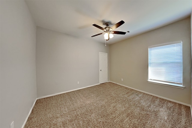 empty room with ceiling fan and carpet floors