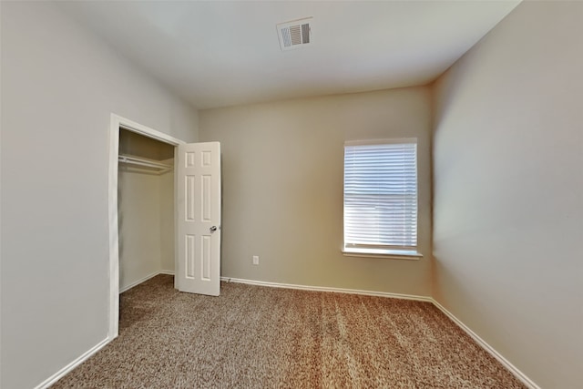 unfurnished bedroom with a closet and carpet flooring