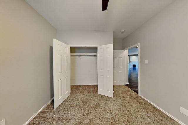 unfurnished bedroom with carpet, a closet, and ceiling fan