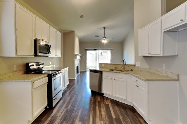 kitchen featuring stainless steel appliances, sink, dark hardwood / wood-style flooring, white cabinetry, and ceiling fan