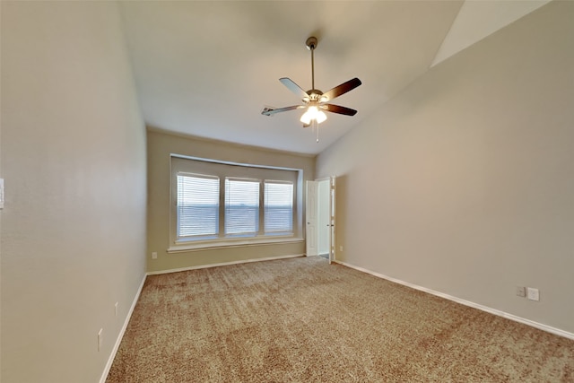 carpeted spare room with vaulted ceiling and ceiling fan