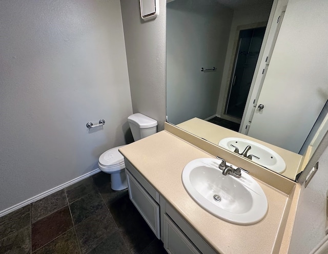 bathroom with toilet and vanity