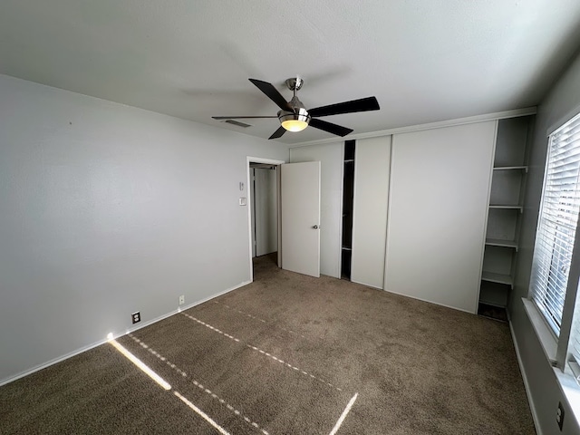 unfurnished bedroom featuring carpet floors and ceiling fan