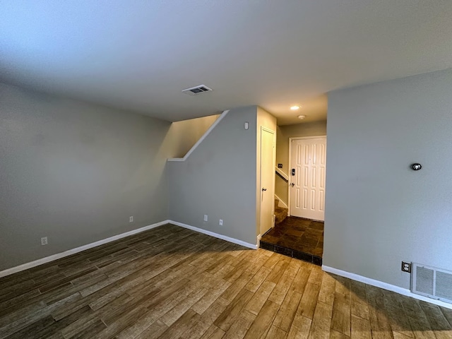 additional living space featuring dark hardwood / wood-style floors