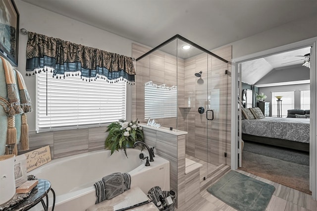 bathroom with independent shower and bath, vaulted ceiling, and ceiling fan