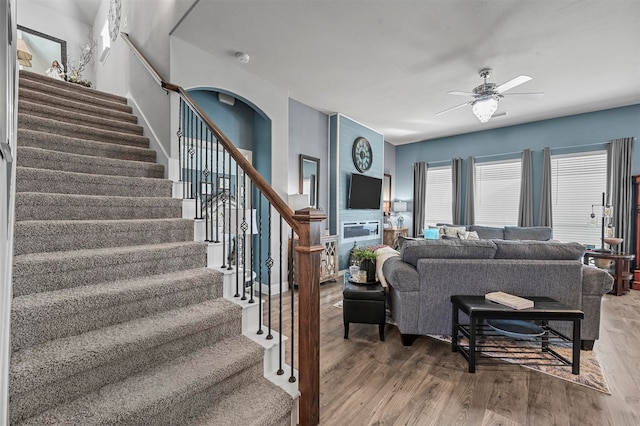 living room featuring ceiling fan and hardwood / wood-style floors