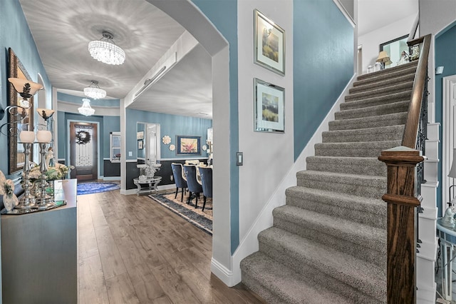 foyer featuring a notable chandelier and wood-type flooring