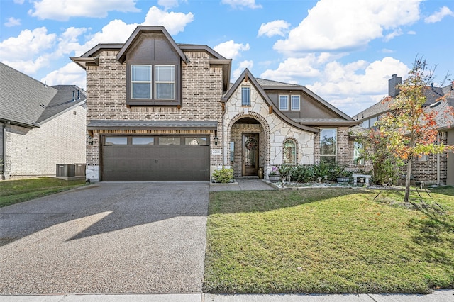 view of front of home featuring central air condition unit, a front lawn, and a garage