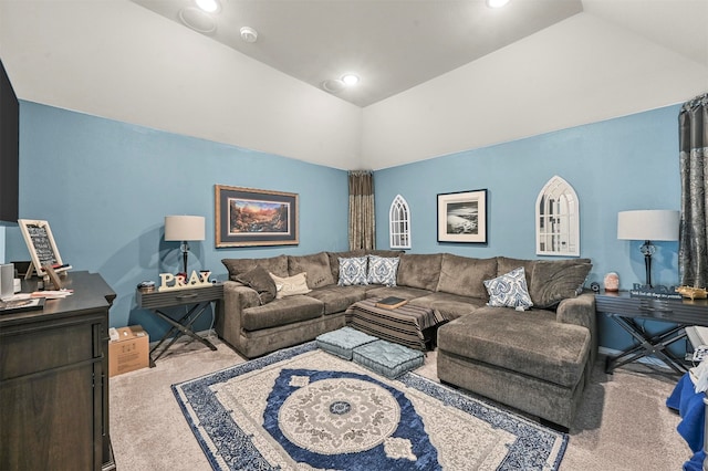 living room with light colored carpet and vaulted ceiling