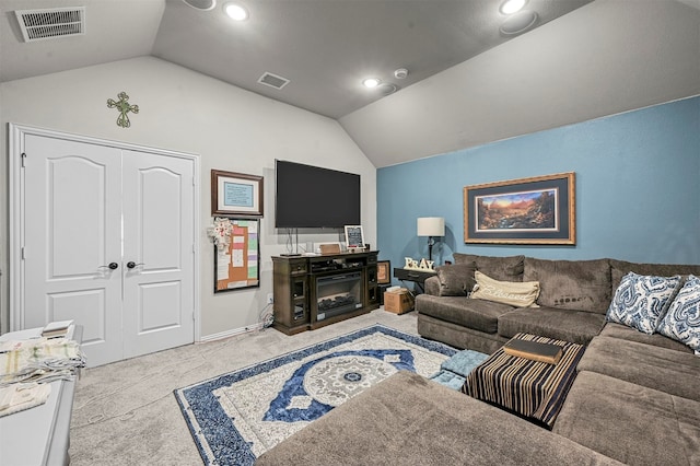 living room with lofted ceiling, a fireplace, and light colored carpet