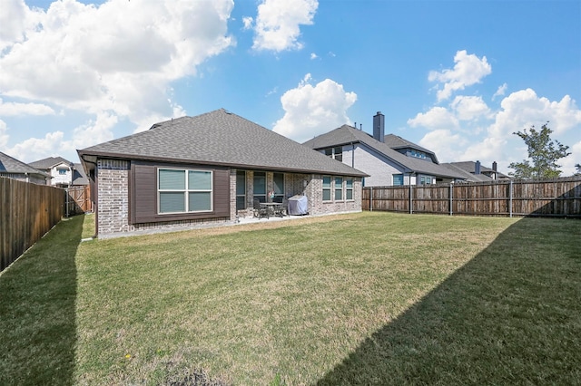 rear view of house with a lawn