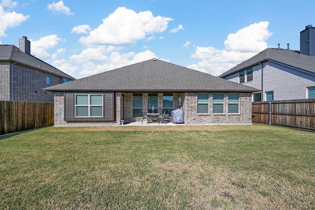 back of property featuring a patio and a yard