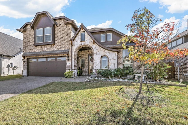 view of front facade featuring driveway, stone siding, brick siding, an attached garage, and a front yard