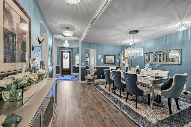 dining area with an inviting chandelier and dark hardwood / wood-style floors