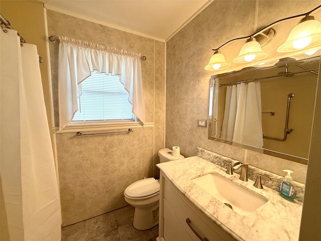 bathroom featuring vanity, toilet, and crown molding