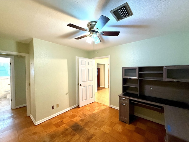 unfurnished office with ceiling fan, light hardwood / wood-style floors, and a textured ceiling