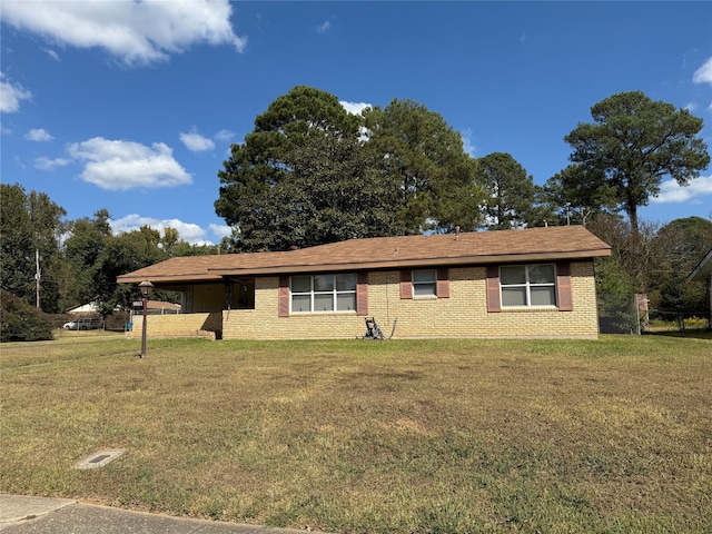 ranch-style home with a front lawn and a carport