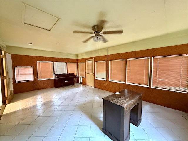 unfurnished sunroom with ceiling fan