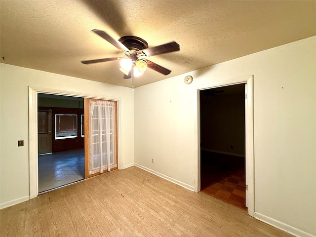 spare room featuring a textured ceiling, light hardwood / wood-style floors, and ceiling fan