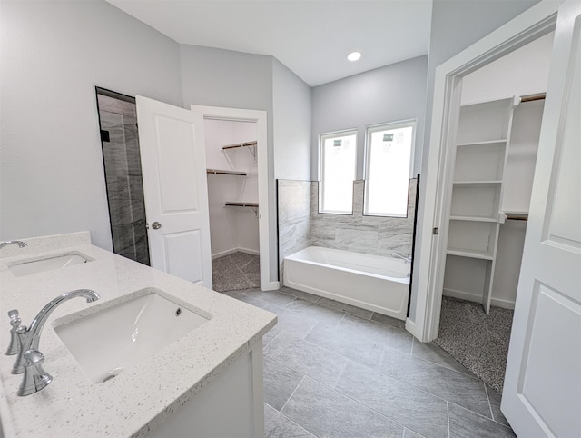 bathroom featuring a washtub and vanity