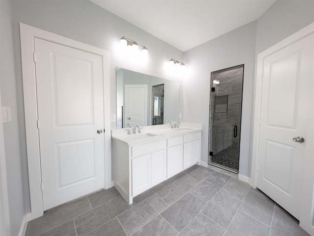 bathroom with tile patterned flooring, vanity, and a shower with door