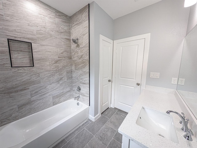 bathroom with vanity and tiled shower / bath