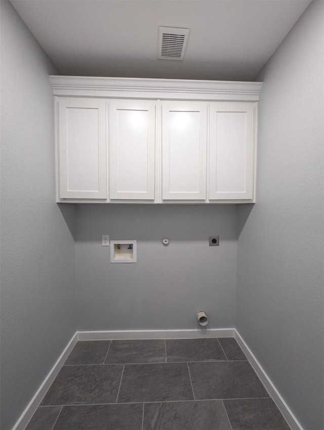 washroom with electric dryer hookup, gas dryer hookup, washer hookup, and dark tile patterned flooring