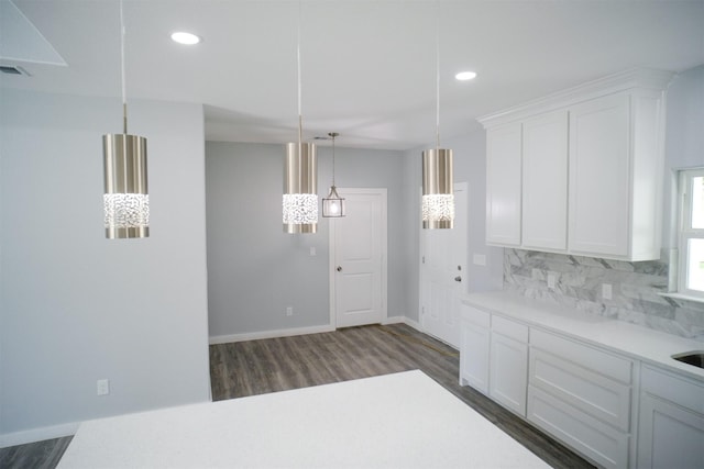 kitchen with white cabinets, decorative backsplash, dark hardwood / wood-style flooring, and hanging light fixtures