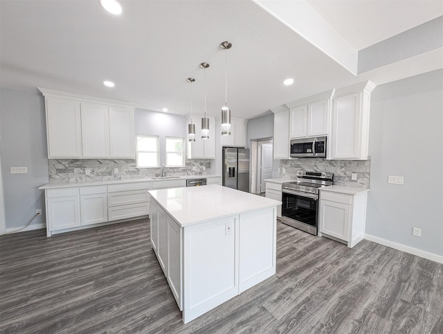 kitchen with decorative light fixtures, dark hardwood / wood-style flooring, white cabinetry, and appliances with stainless steel finishes