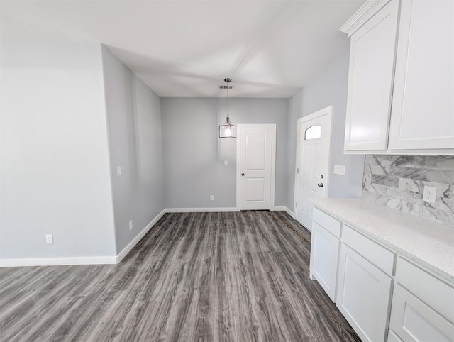 unfurnished dining area featuring dark hardwood / wood-style floors