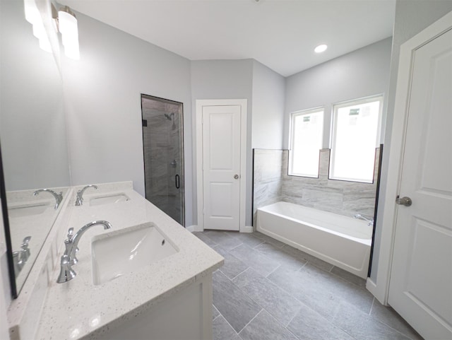 bathroom featuring shower with separate bathtub and vanity