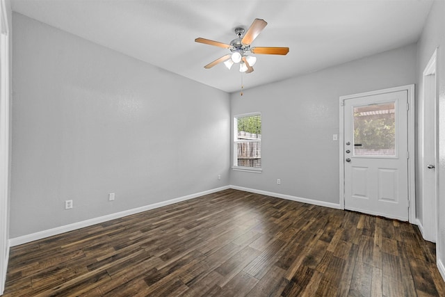 unfurnished room with dark wood-type flooring and ceiling fan