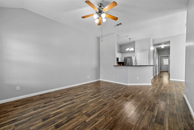 unfurnished living room featuring lofted ceiling, dark hardwood / wood-style floors, and ceiling fan with notable chandelier