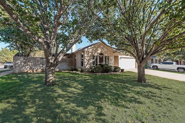 single story home featuring a front lawn and a garage