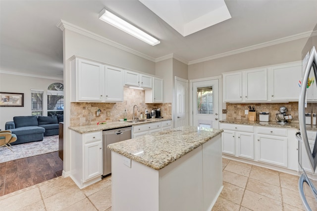 kitchen featuring stainless steel appliances, sink, and white cabinets