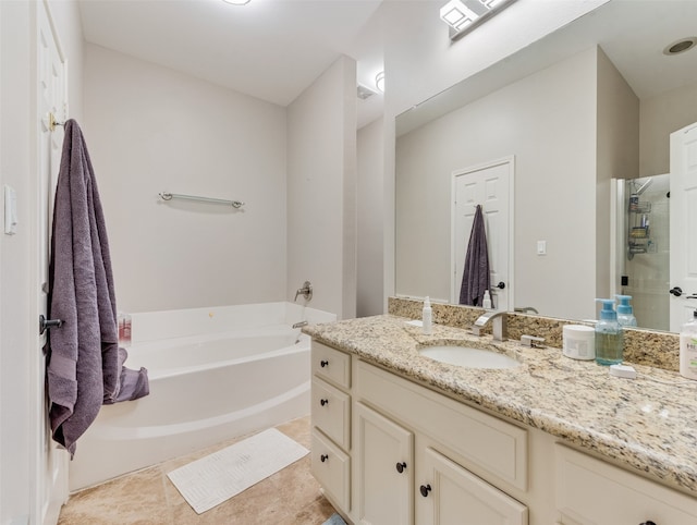 bathroom featuring vanity, independent shower and bath, and tile patterned flooring