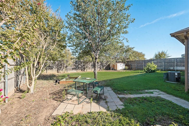 view of yard featuring central air condition unit, a patio area, and a shed