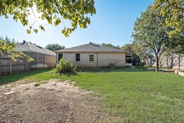 back of house with a yard