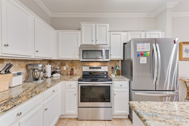 kitchen with appliances with stainless steel finishes, crown molding, white cabinetry, and tasteful backsplash