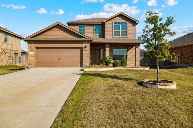 craftsman-style home featuring a front lawn and a garage