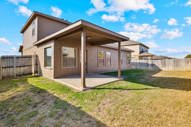 rear view of house featuring a patio and a lawn