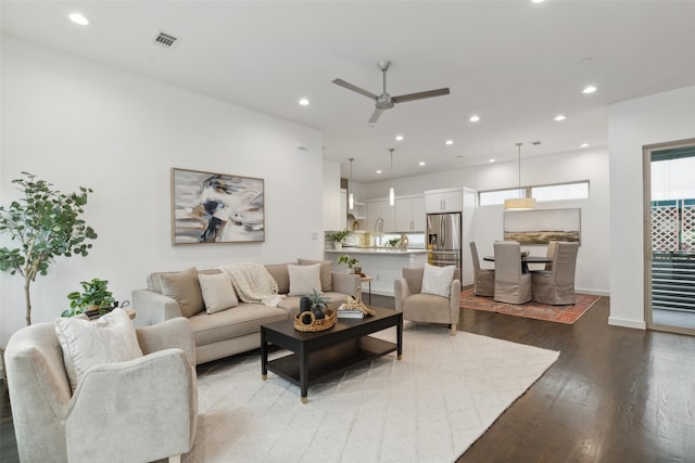 living room featuring light hardwood / wood-style floors and ceiling fan