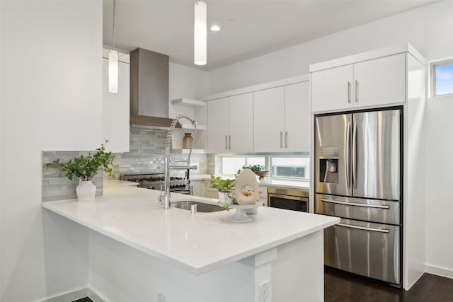 kitchen with white cabinets, a healthy amount of sunlight, appliances with stainless steel finishes, and hanging light fixtures