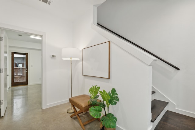 staircase featuring concrete flooring