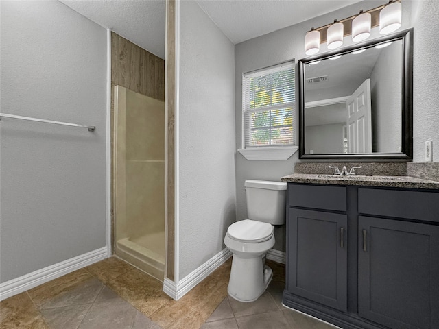 bathroom with toilet, tile patterned flooring, a shower, vanity, and a textured ceiling