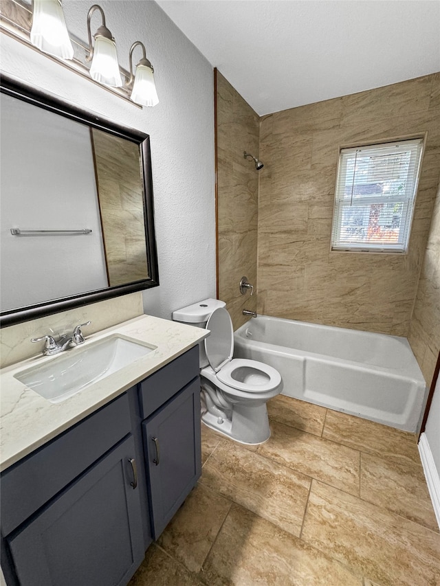 full bathroom with vanity, tiled shower / bath combo, and toilet