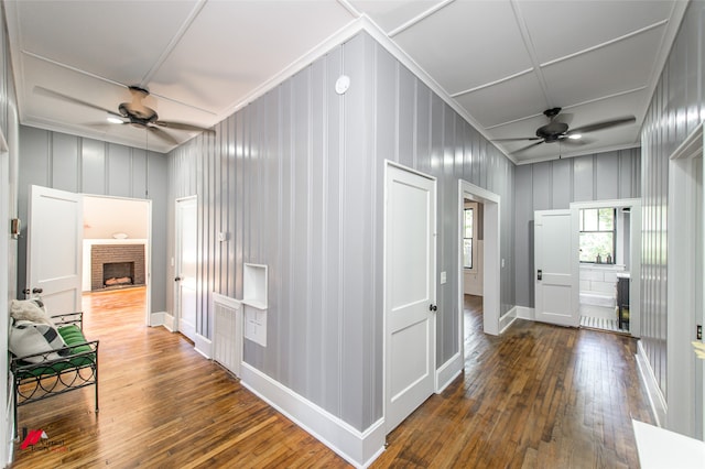 corridor with crown molding and dark hardwood / wood-style floors