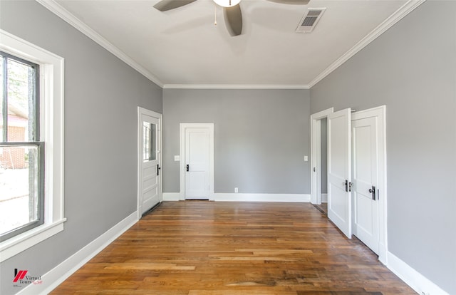 empty room with ornamental molding, dark hardwood / wood-style floors, and ceiling fan