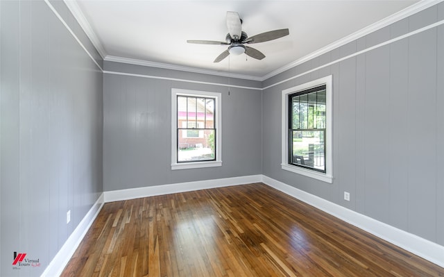 spare room featuring dark wood-type flooring, crown molding, and ceiling fan