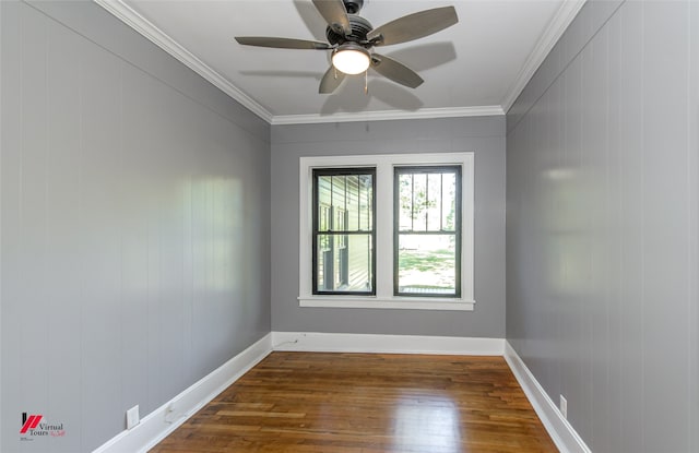 empty room featuring crown molding, dark hardwood / wood-style floors, wooden walls, and ceiling fan